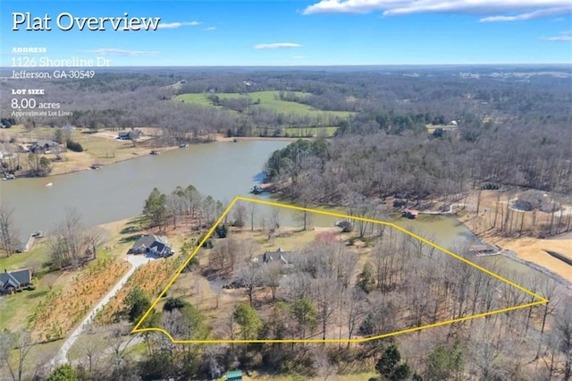 aerial view featuring a forest view and a water view