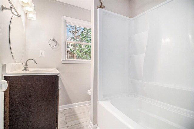 bathroom with vanity and bathtub / shower combination