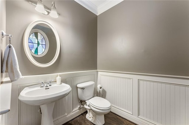 bathroom with ornamental molding, hardwood / wood-style floors, toilet, and sink