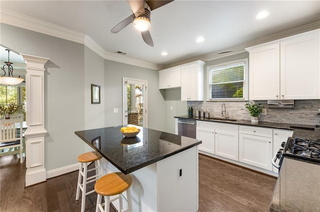 kitchen featuring white cabinetry, a healthy amount of sunlight, decorative columns, and dark hardwood / wood-style flooring