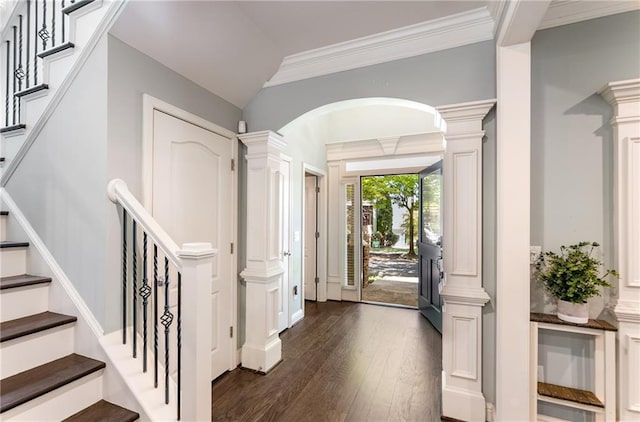 entryway with crown molding, dark wood-type flooring, and ornate columns