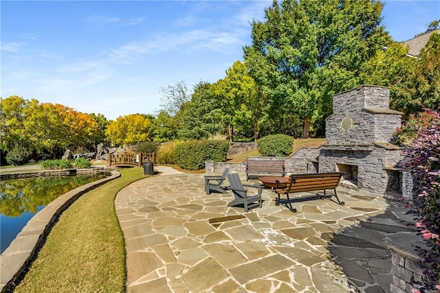 view of property's community with a water view and a patio