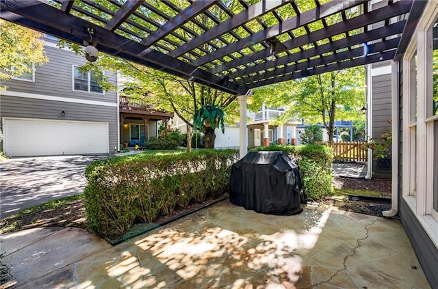 view of patio / terrace with area for grilling, a garage, and a pergola