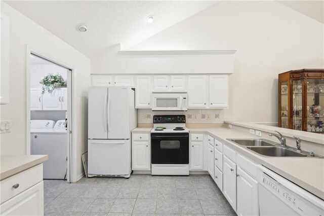 kitchen with washer and dryer, white cabinetry, white appliances, and sink