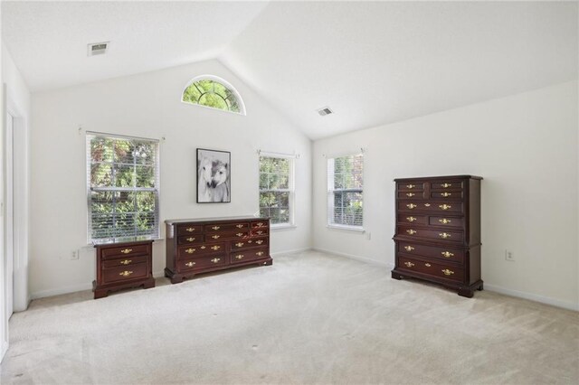 unfurnished bedroom featuring light carpet and vaulted ceiling