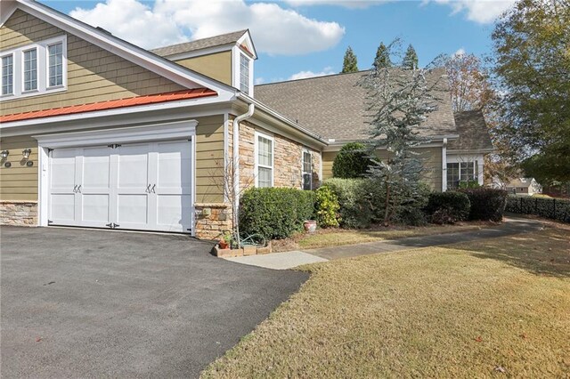 view of front facade with a front yard and a garage