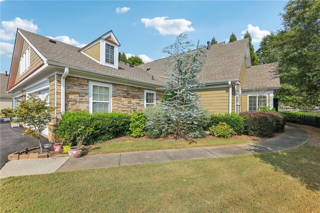 cape cod home with a garage and a front yard