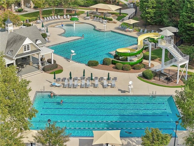 view of pool featuring a patio area and a water slide