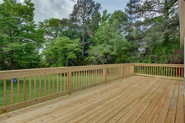 wooden terrace featuring a lawn
