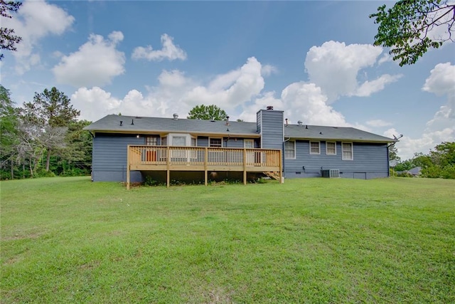back of property with central air condition unit, a wooden deck, a chimney, and a yard