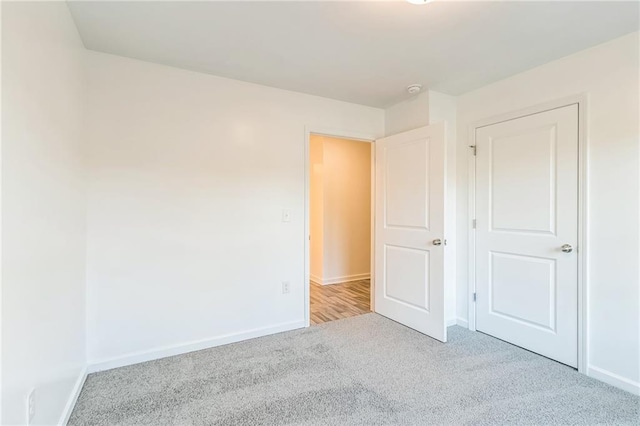 unfurnished bedroom featuring light colored carpet