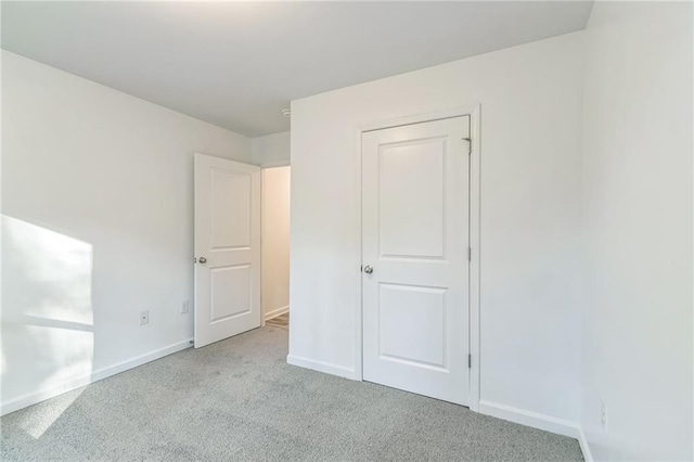 unfurnished bedroom featuring light carpet