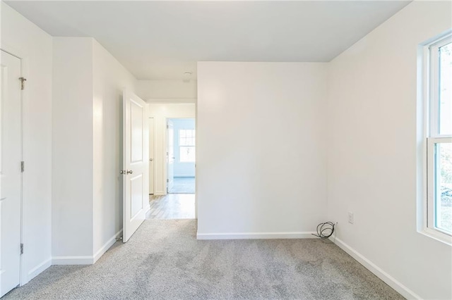 carpeted empty room with a wealth of natural light