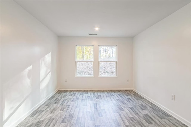 unfurnished room with light hardwood / wood-style floors