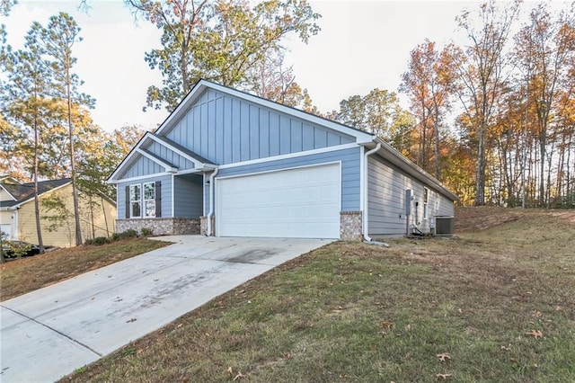 view of front of house with a front lawn, a garage, and central AC