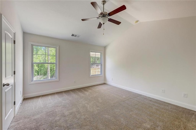 unfurnished room with lofted ceiling, light colored carpet, and ceiling fan