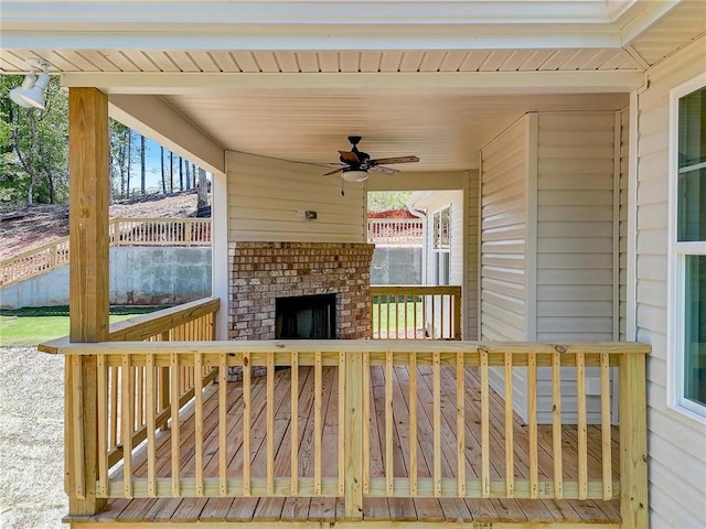 view of patio / terrace featuring an outdoor brick fireplace and ceiling fan