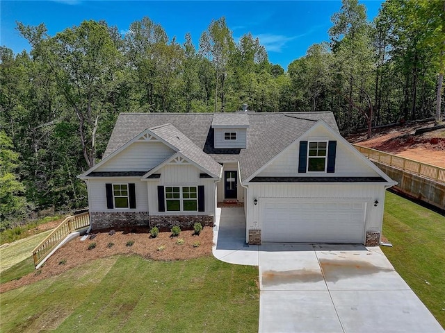 view of front of property featuring a garage and a front lawn