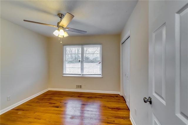 unfurnished room with hardwood / wood-style flooring and ceiling fan