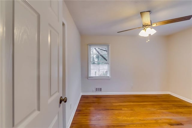 unfurnished room with hardwood / wood-style floors and ceiling fan