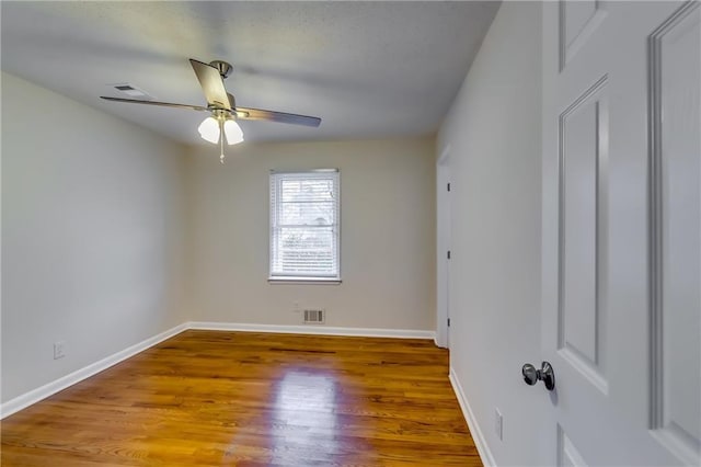 unfurnished room featuring hardwood / wood-style floors and ceiling fan