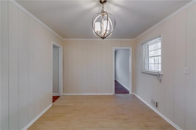 unfurnished dining area featuring a notable chandelier, ornamental molding, and light wood-type flooring