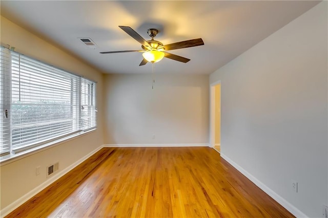 empty room featuring ceiling fan and light hardwood / wood-style flooring