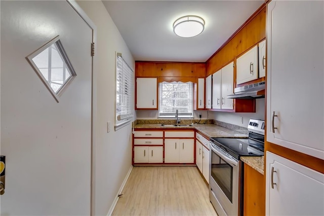 kitchen featuring white cabinets, sink, electric range, and light hardwood / wood-style flooring