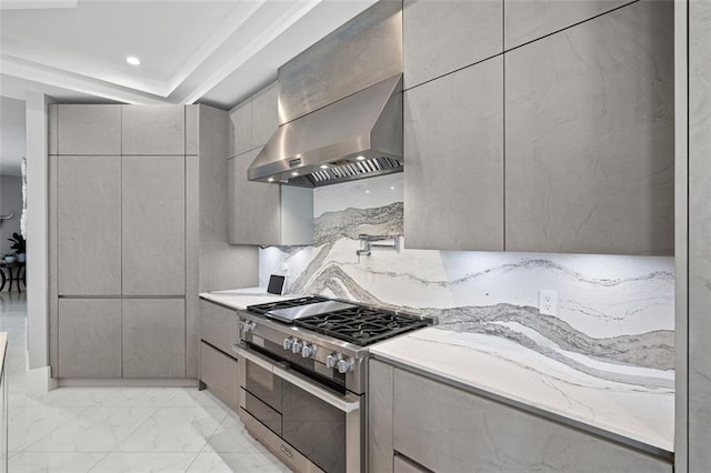 kitchen with modern cabinets, marble finish floor, gray cabinets, wall chimney range hood, and double oven range