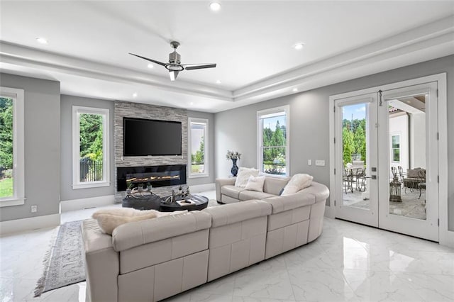 living area featuring ceiling fan, marble finish floor, french doors, a fireplace, and recessed lighting