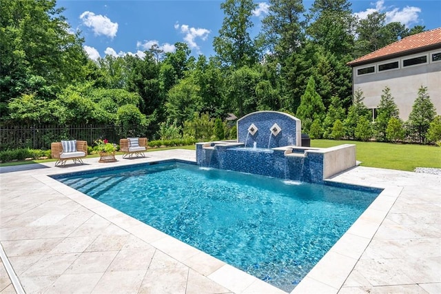 view of swimming pool featuring a patio, an outdoor structure, fence, a yard, and a fenced in pool