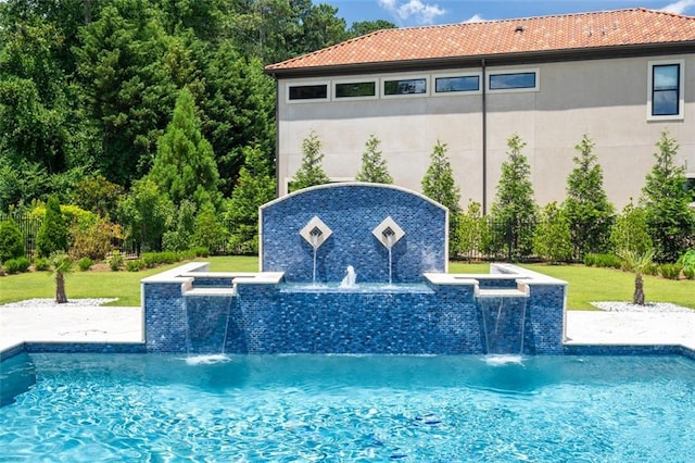 outdoor pool with a yard and a jacuzzi