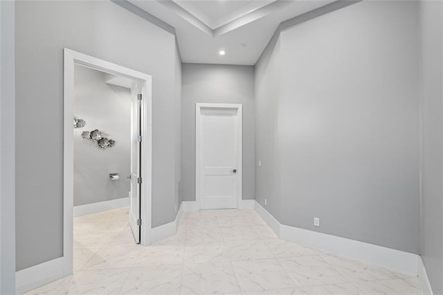 hall with marble finish floor, recessed lighting, and baseboards