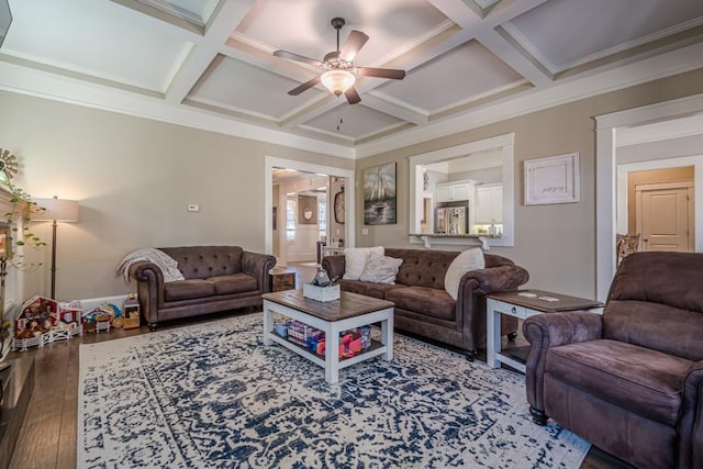 living room featuring hardwood / wood-style flooring, ornamental molding, and coffered ceiling