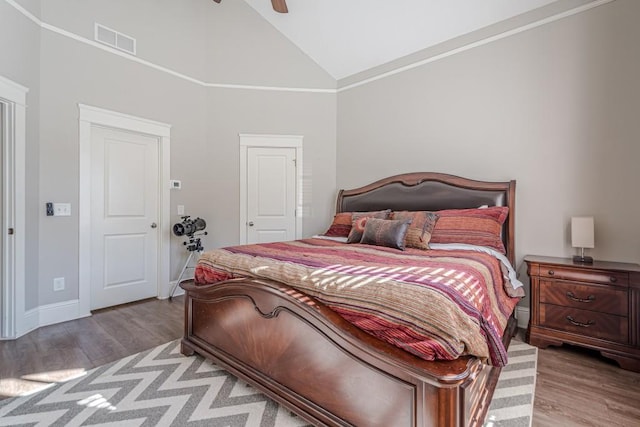 bedroom featuring light hardwood / wood-style flooring, high vaulted ceiling, and ceiling fan