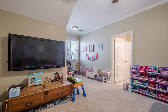 recreation room with light carpet, crown molding, and ceiling fan