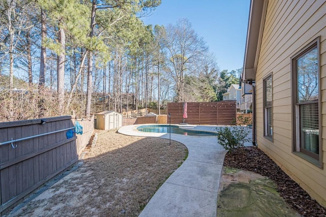 view of yard featuring a fenced in pool and a storage unit