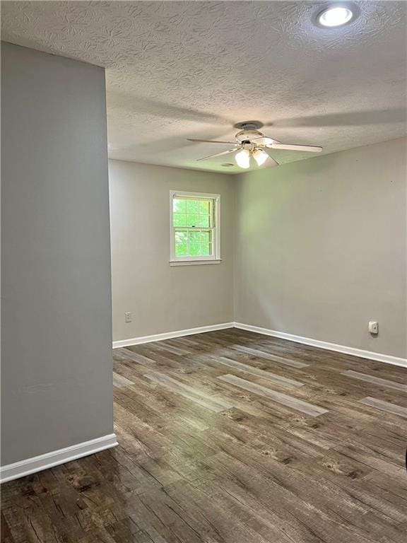 5607 Mountainbrooke Ct, Stone Mountain, GA 30087 - empty room featuring dark wood-style flooring, baseboards, a ceiling fan, and a textured ceiling