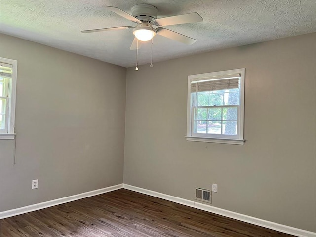 5607 Mountainbrooke Ct, Stone Mountain, GA 30087 - empty room featuring baseboards, dark wood finished floors, a ceiling fan, and a textured ceiling