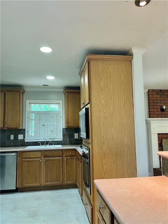 5607 Mountainbrooke Ct, Stone Mountain, GA 30087 - kitchen with appliances with stainless steel finishes, decorative backsplash, light countertops, brown cabinetry, and ornamental molding