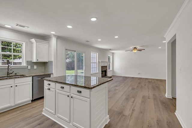 895 Roxfield Ct, Buford, GA 30518 - kitchen featuring a sink, stainless steel dishwasher, a ceiling fan, a fireplace, and tasteful backsplash