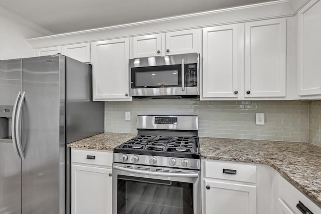 895 Roxfield Ct, Buford, GA 30518 - kitchen featuring appliances with stainless steel finishes, decorative backsplash, white cabinetry, ornamental molding, and light stone counters