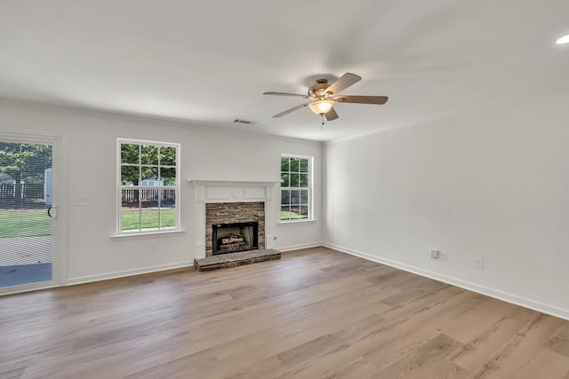 895 Roxfield Ct, Buford, GA 30518 - unfurnished living room featuring ceiling fan, wood finished floors, baseboards, and a stone fireplace