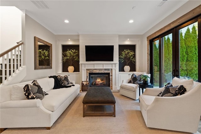 living area with visible vents, recessed lighting, a fireplace, and ornamental molding