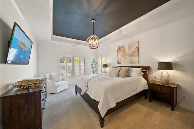 carpeted bedroom featuring an inviting chandelier, a raised ceiling, and crown molding