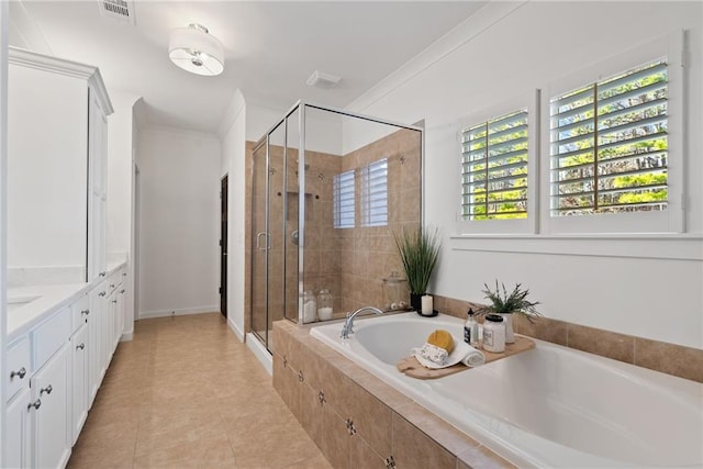 bathroom featuring a garden tub, crown molding, visible vents, and a stall shower