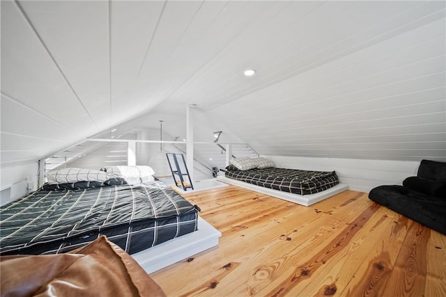 bedroom with lofted ceiling and hardwood / wood-style floors