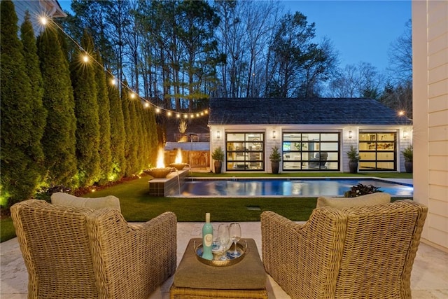 outdoor pool featuring fence, a storage structure, a yard, an outdoor structure, and a patio area