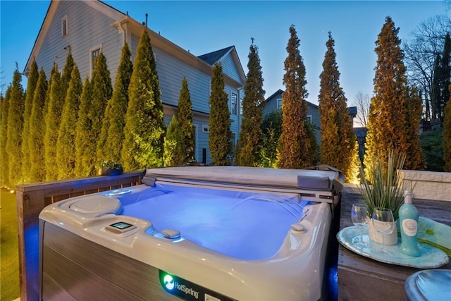 view of swimming pool featuring a hot tub