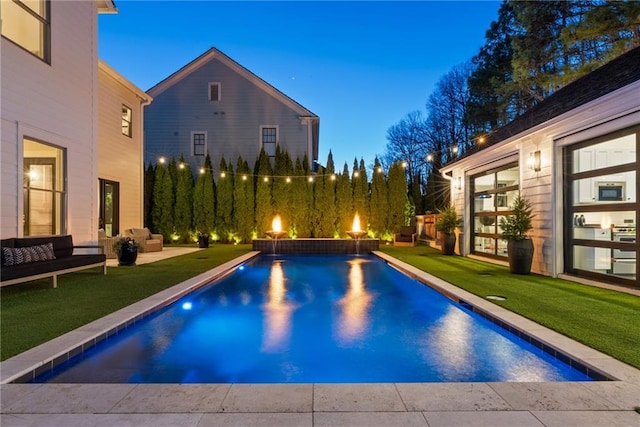 outdoor pool featuring an outdoor hangout area, a lawn, and a patio area